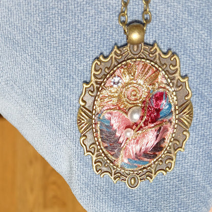 One of a kind, handmade Fabric Pendant. Elegant, brocade ribbon fabric. Arranged in an old fashion historical Cameo bezel. adjustable length