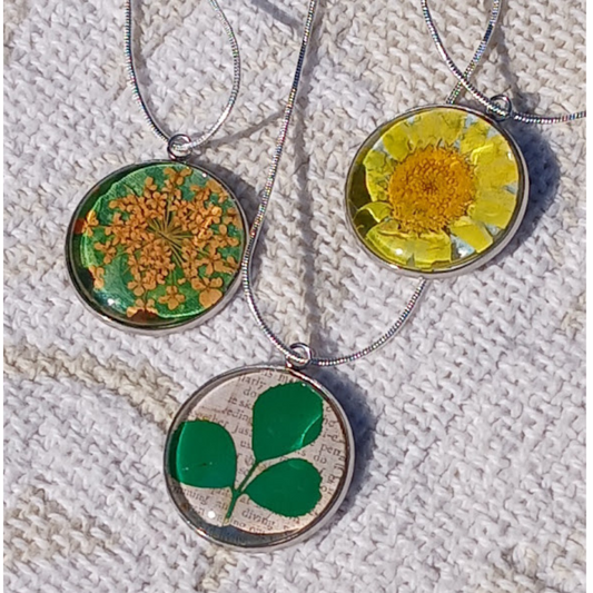 One of a Kind Colorful and Fun Necklaces made with Real dried flowers;  also purchased bezel, acrylic cabochon and chain complete the piece.