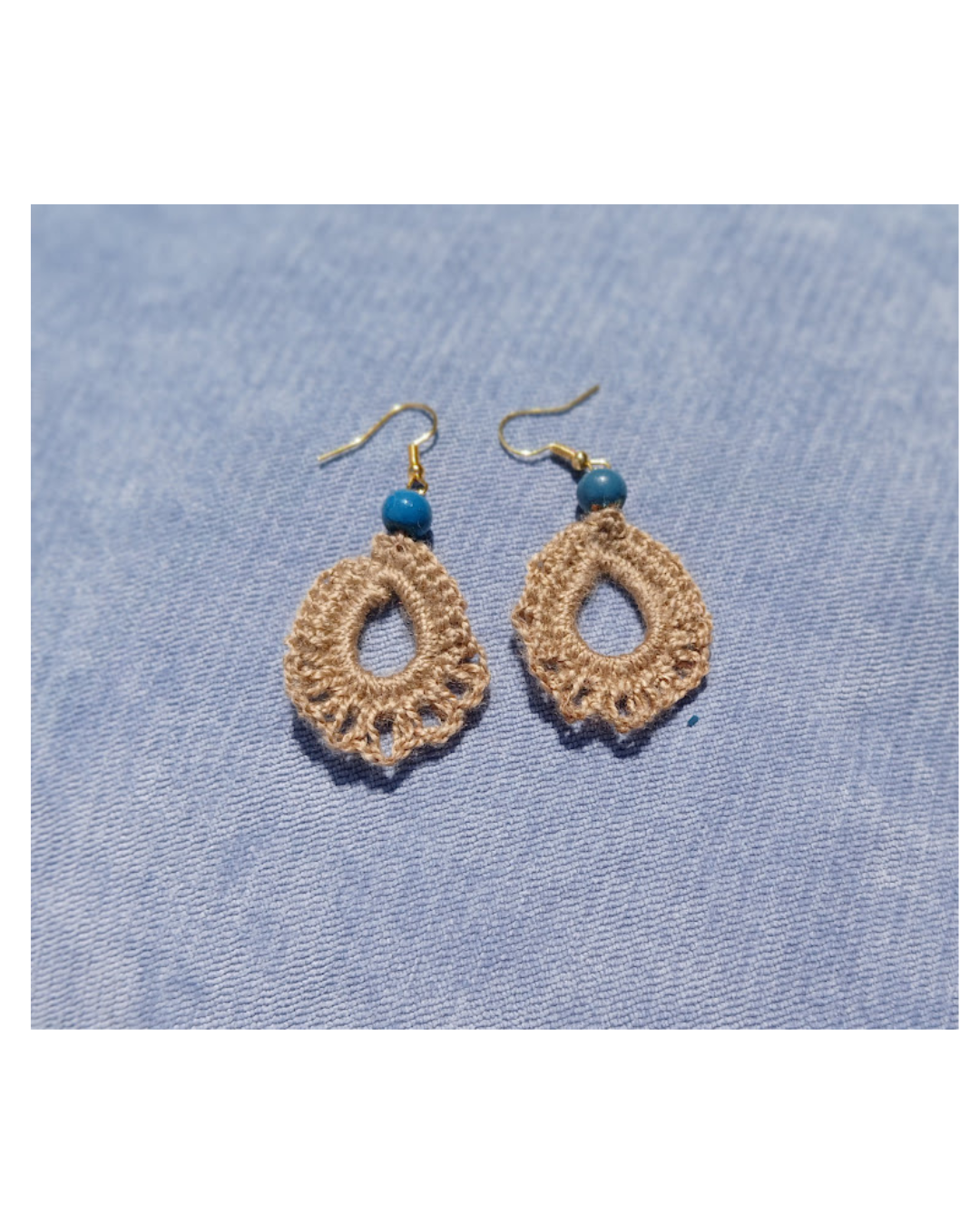 hand crocheted earrings with a blue bead. very light weight