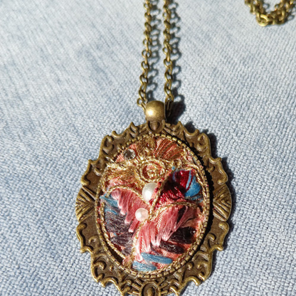 One of a kind, handmade Fabric Pendant. Elegant, brocade ribbon fabric. Arranged in an old fashion historical Cameo bezel. adjustable length