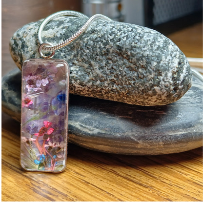 Whimsical Handmade Necklace-Dried flowers in bezel under clear acrylic Cabochon. The curve of the acrylic creates variety of colors, shapes