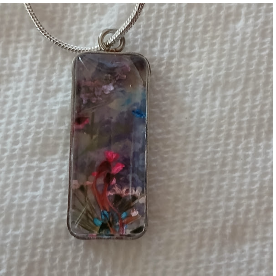 Whimsical Handmade Necklace-Dried flowers in bezel under clear acrylic Cabochon. The curve of the acrylic creates variety of colors, shapes